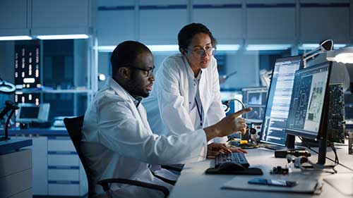 A man and a woman working in a research setting.